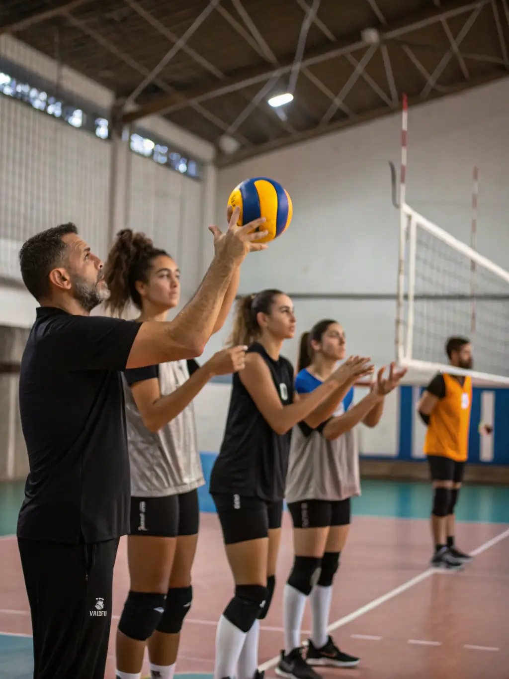 Image of a volleyball coaching clinic, with experienced coaches providing guidance and instruction to aspiring players, set in a well-equipped training facility.