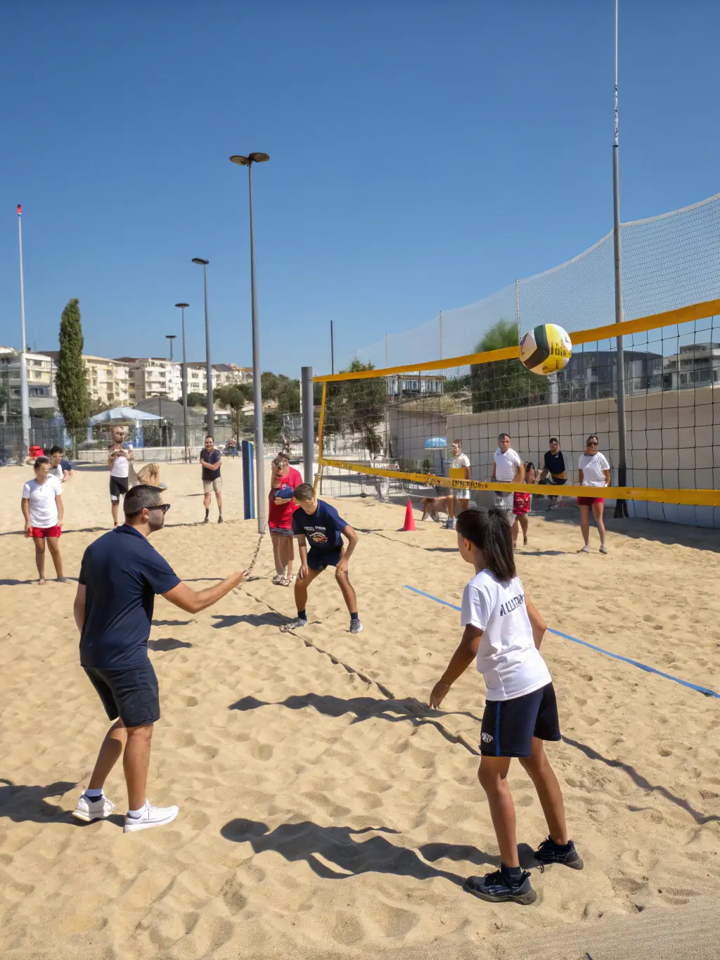 Action shot of young volleyball players practicing drills during a youth program session at LOUVIERS ARCHE VOLLEY BALL, focusing on teamwork and skill development.